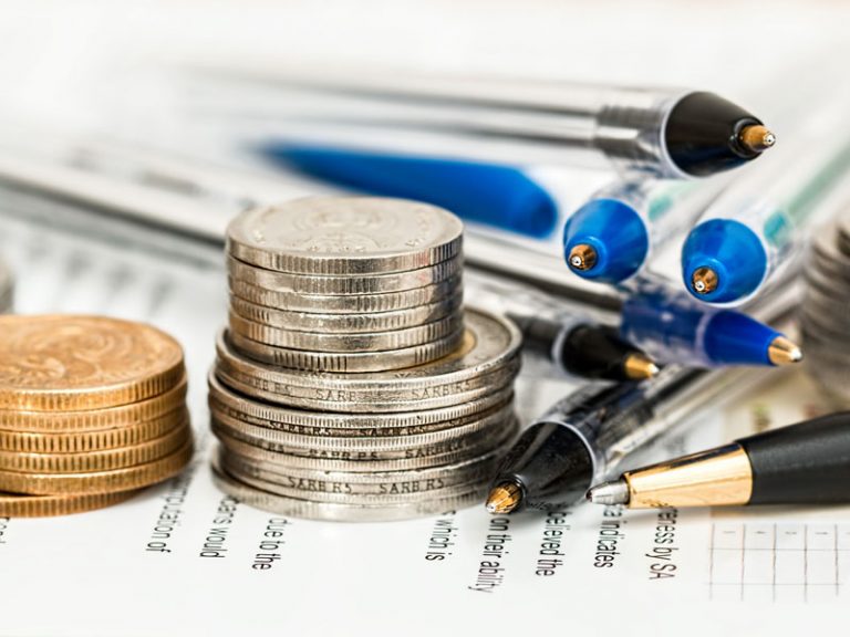 Coins and pens at tax time