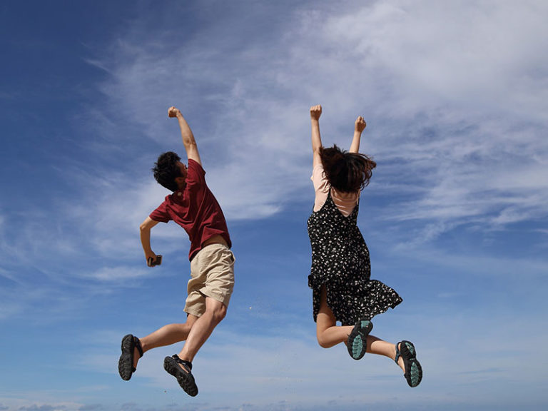 Two people jumping hooray