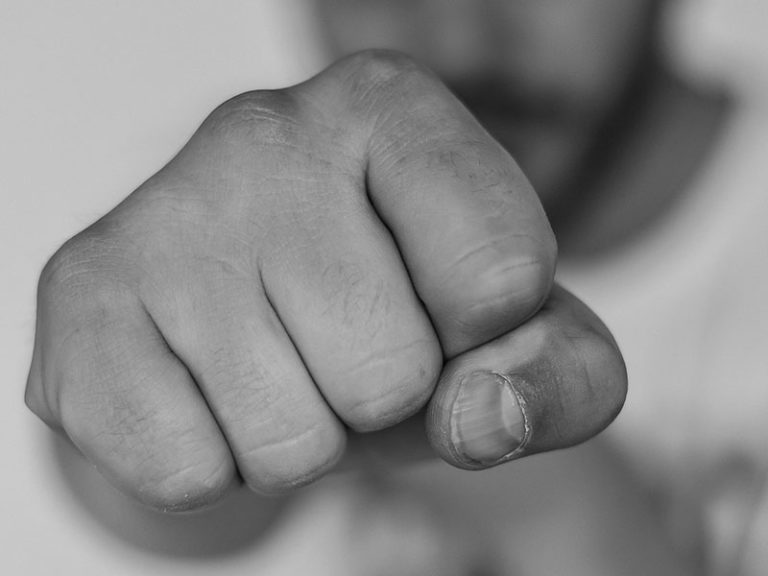 A guys fist clenched ready to punch